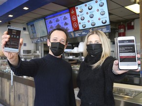 Thanos Zikantas, left, owner of Sofos Greek Restaurant has developed Jubzi, a takeout delivery platform. He is shown with his sister and business associate Maria Krikellas at the Windsor restaurant on Thursday.