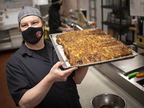 Shawn Welsh, sous-chef at the Loose Goose RestoPub & Lounge, prepares racks of ribs for tomorrow's Super Bowl orders, Saturday, Feb. 6, 2021.