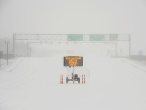 FILE PHOTO: A sign warns motorists after a sudden heavy bout of snow and frozen rain on MS Highway 463 in Madison, north of Jackson, Mississippi, U.S. February 15, 2021.