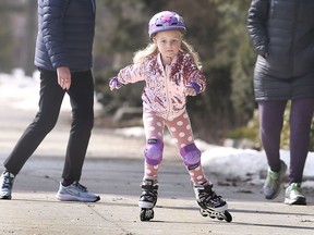 Margot McLinden-Byrne, 5, enjoys the spring-like weather on Wednesday, February 24, 2021 at Windsor's Jackson Park. She was accompanied by Wanda and Leah McLinden.