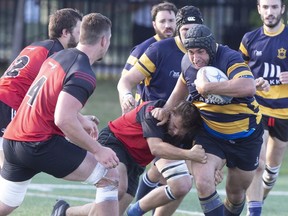Town of Mount Royal RFC (in blue) takes on Club de Rugby de Québec in 2019. "The outdoor transmission risk even during tackles is probably lower than we first thought," said the lead researcher in a study of COVID-19 infections among rugby players.