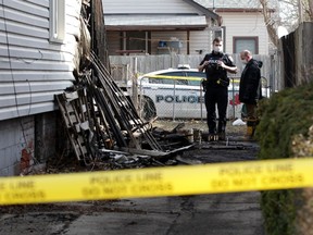 Windsor police officers examine the aftermath of a fire in the 500 block of Church Street on March 9, 2021.