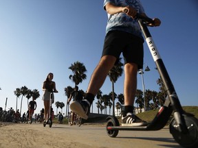 People ride Bird shared dockless electric scooters along Venice Beach on August 13, 2018 in Los Angeles, California. Shared e-scooter startups Bird and Lime have rapidly expanded in the city. Windsor has reached an agreement with Bird.