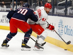 Riley Nash of the Columbus Blue Jackets and Luke Glendening of the Detroit Red Wings battle for control of the puck during the third period at Nationwide Arena on March 2, 2021 in Columbus, Ohio. Columbus defeated Detroit 4-1.