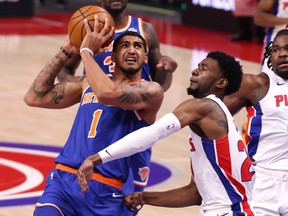 Obi Toppin of the New York Knicks drives to the basket against Josh Jackson #20 of the Detroit Pistons during the first half at Little Caesars Arena on February 28, 2021 in Detroit, Michigan.