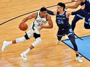 Giannis Antetokounmpo of the Milwaukee Bucks goes to the basket against Dillon Brooks of the Memphis Grizzlies during the first half at FedExForum on March 04, 2021 in Memphis, Tennessee.