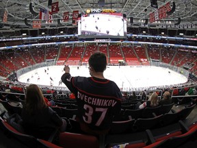 A young fan looks on during the third period of the game between the Carolina Hurricanes and the Detroit Red Wings at PNC Arena on March 04, 2021 in Raleigh, North Carolina.