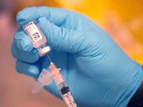 Dr. Mark McGuire prepares a COVID-19 vaccine for a United Airlines employee at United's onsite clinic at O'Hare International Airport on March 9, 2021, in Chicago, Illinois.