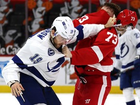 Barclay Goodrow of the Tampa Bay Lightning and Adam Erne of the Detroit Red Wings fight during the second period at Little Caesars Arena on March 11, 2021 in Detroit, Michigan.