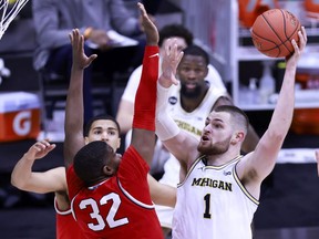 Hunter Dickinson of the Michigan Wolverines takes a shot over E.J. Liddell of the Ohio State Buckeyes during the second half of the Big Ten men's basketball tournament semifinals at Lucas Oil Stadium on March 13, 2021 in Indianapolis, Indiana.