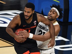 LAS VEGAS, NEVADA - MARCH 13:  Evan Battey #21 of the Colorado Buffaloes tries to steal the ball from Maurice Calloo #1 of the Oregon State Beavers during the championship game of the Pac-12 Conference basketball tournament at T-Mobile Arena on March 13, 2021 in Las Vegas, Nevada.