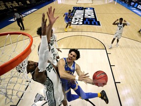 Jules Bernard of the UCLA Bruins attempts the layup against the Michigan State Spartans during overtime in the First Four game prior to the NCAA Men's Basketball Tournament at Mackey Arena on March 18, 2021 in West Lafayette, Indiana.
