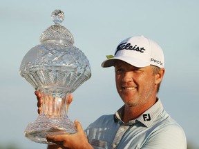 Matt Jones of Australia celebrates with the trophy after winning during the final round of The Honda Classic at PGA National Champion course on March 21, 2021 in Palm Beach Gardens, Florida.