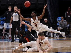 Keith Clemons of the Loyola-Chicago Ramblers leaps for a loose ball against the Oregon State Beavers during the second half in the Sweet Sixteen round of the 2021 NCAA Men's Basketball Tournament at Bankers Life Fieldhouse on March 27, 2021 in Indianapolis, Indiana.
