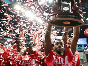 DeJon Jarreau of the Houston Cougars hoists the Midwest Regional Champion trophy after defeating the against the Oregon State Beavers in the Elite Eight round of the 2021 NCAA Men's Basketball Tournament at Lucas Oil Stadium on March 29, 2021 in Indianapolis, Indiana.