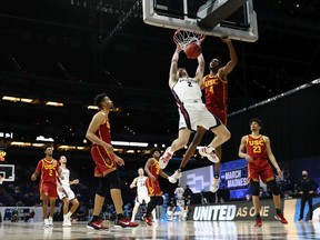 Drew Timme of the Gonzaga Bulldogs dunks the ball against Evan Mobley #4 of the USC Trojans during the first half in the Elite Eight round game of the 2021 NCAA Men's Basketball Tournament at Lucas Oil Stadium on March 30, 2021 in Indianapolis, Indiana.