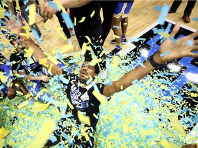 Chris Smith of the UCLA Bruins celebrates defeating the Michigan Wolverines 51-49 in the Elite Eight round game of the 2021 NCAA Men's Basketball Tournament at Lucas Oil Stadium on March 30, 2021 in Indianapolis, Indiana.