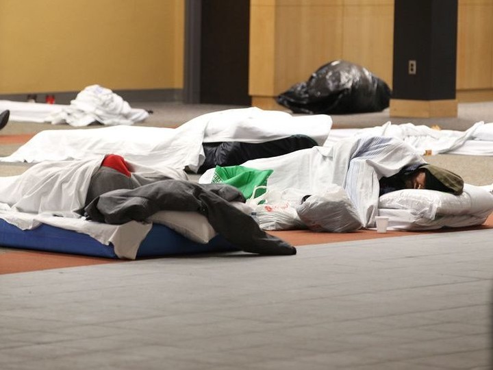  People rest on the first floor of the former Windsor Public Library main branch building on Ouellette Avenue which was being used as a temporary homeless shelter in February.