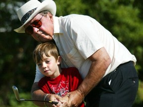 Eric Widdifield, who started the Burger King Junior Golf Tour in 1988, is seen in this 2002 file photo giving golf tips at the CAW Children's Day Care Centre. He passed away last week at the age of 77.