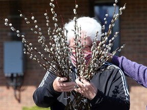 Pussy willow customer Paul McNamara bundles his purchase from volunteers with Save the Children Canada at Tecumseh United Church in Tecumseh Wednesday, March 24, 2021.