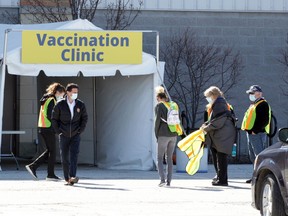 Amherstburg Mayor Aldo DiCarlo, centre, departs the COVID-19 Vaccination clinic at Libro Recreation Centre Monday, March 29, 2021.