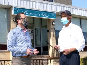 Bruce Villa retirement home owner Vino Patel, right, discusses a thermal sensing camera system with Dave Fortin of DataRealm Wednesday March 31, 2021.