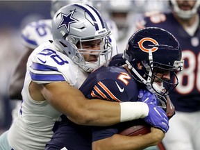 Tyrone Crawford of the Dallas Cowboys tackles Brian Hoyer of the Chicago Bears in the first quarter during a game between the Dallas Cowboys and the Chicago Bears at AT&T Stadium on September 25, 2016 in Arlington, Texas.