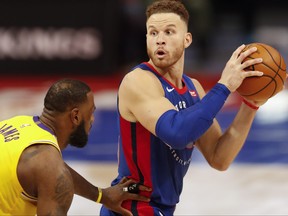 Detroit Pistons forward Blake Griffin, right, holds onto the ball while defended by Los Angeles Lakers forward LeBron James at Little Caesars Arena in Detroit, Mich., Jan. 28, 2021.