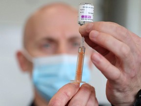 A dose of Oxford-AstraZeneca COVID-19 vaccine is prepared by a member of the Hampshire Fire and Rescue Service in Basingstoke, Britain, on Feb. 4, 2021.