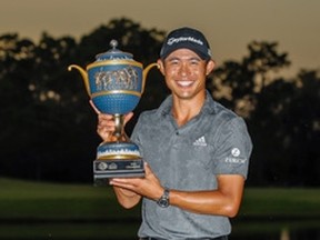 Collin Morikawa poses with the trophy after winning the World Golf Championships at The Concession on Sunday.