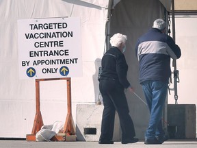 Two senior citizens enter the mass COVID-19 vaccination clinic at the WFCU Centre in Windsor on March 1, 2021.