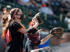 Fans wait for a foul ball during a spring training game between the Chicago White Sox and the San Francisco Giants at Scottsdale Stadium on March 4, 2021 in Scottsdale, Arizona.