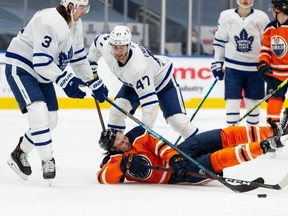Oilers forward Joakim Nygard is taken down by Toronto Maple Leafs’ Pierre Engvall during one of the early-March blowout games won by the Leafs. IAN KUCERAK/POSTMEDIA
