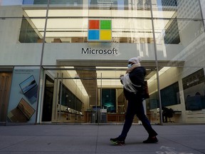 A person walks past a Microsoft store in the Manhattan borough of New York, January 25, 2021.