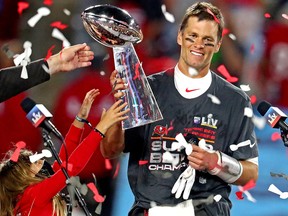 Tampa Bay Buccaneers quarterback Tom Brady (12) celebrates with the Vince Lombardi Trophy after beating the Kansas City Chiefs in Super Bowl LV at Raymond James Stadium.