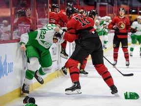 Senators' Austin Watson fights Maple Leafs' Zach Bogosian (left) on Sunday, March 14, 2021 at Canadian Tire Centre in Ottawa.