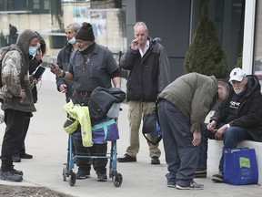 Clients of the Downtown Mission wait outside of the Windsor International Aquatic Centre on Wednesday, March 10, 2021 where the city has set up a temporary shelter.