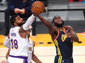 Los Angeles Lakers forward Markieff Morris defends a shot by Golden State Warriors forward Eric Paschall as he drives to the basket in the first half of the game at Staples Center.