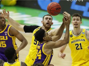 Indianapolis, Indiana, USA; Louisiana State Tigers guard Cameron Thomas (24) and Michigan Wolverines forward Austin Davis (51) battle for a rebound during the second half in the second round of the 2021 NCAA Tournament at Lucas Oil Stadium. Mandatory Credit: Joshua Bickel-USA TODAY Sports