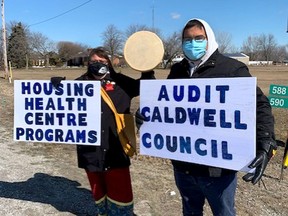 Handout/Chatham Daily News Caldwell First Nation members Angela Duckworth and Jesse Savoie were among those protesting in front of the Happy Snapper Marina and restaurant in Leamington on Saturday over concerns about a lack of information regarding a 600-seat restaurant the Caldwell band council plans to construct at the site.