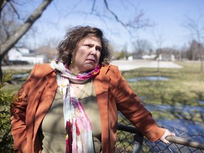 Tamra Tobin Teno, whose home on Little River Road in Tecumseh backs onto the former Victoria school land where condominium development is to take place, is pictured in her backyard on Monday, March 29, 2021.