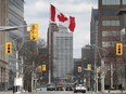 The Great Canadian Flag flies over the foot of Ouellette Avenue in downtown Windsor on March 25, 2021.
