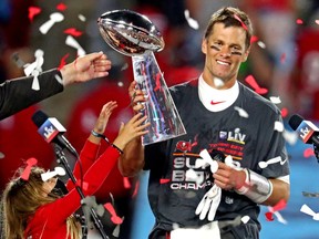 Tampa Bay Buccaneers quarterback Tom Brady (12) celebrates with the Vince Lombardi Trophy after beating the Kansas City Chiefs in Super Bowl LV at Raymond James Stadium, Feb. 7, 2021.