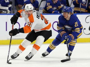 Philadelphia Flyers left wing Scott Laughton skates with the puck against Buffalo Sabres center Cody Eakin during the second period at KeyBank Center.
