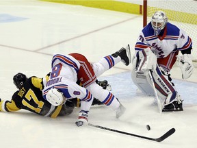 New York Rangers defenceman Jacob Trouba (8) and goaltender Keith Kinkaid (71) defend Pittsburgh Penguins right wing Bryan Rust (17) during the third period at PPG Paints Arena in Pittsburgh on March 7, 2021. The Penguins won 5-1.