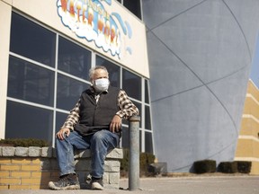 Stephen Webster, who is currently experiencing homelessness, sits Monday outside Windsor Water World, which is currently being used as a homeless shelter.