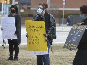 Lacie Krzemien. left, Lisa Valente and Lucie Bellerive participate in a protest on Thursday, March 11, 2021 in front of Windsor City Hall speaking out against the treatment of homeless people in the community.