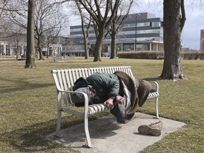 WINDSOR, ONTARIO. MARCH 11, 2021 -   A man sleeps on a bench near City Hall Square on Thursday, March 11, 2021.