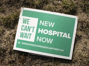 A 'We Can't Wait' sign, urging the development of the Windsor Essex single acute-care hospital lays on the ground at the site of the future hospital at Concession Rd. 9 and County Rd. 42 on Wednesday, March 24, 2021.