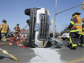 Windsor firefighters are shown at the scene of a collision between a vehicle and a Transit Windsor bus on Wednesday, March 17, 2021. The accident occurred at approximately 2:45 p.m. on Howard Ave. at the E.C. Row westbound on ramp. At least one passenger on the bus was taken to hospital by ambulance as well as the motorist that was extricated. Injuries were not life threatening.